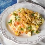 The creamy chicken and rice served on a white plate.