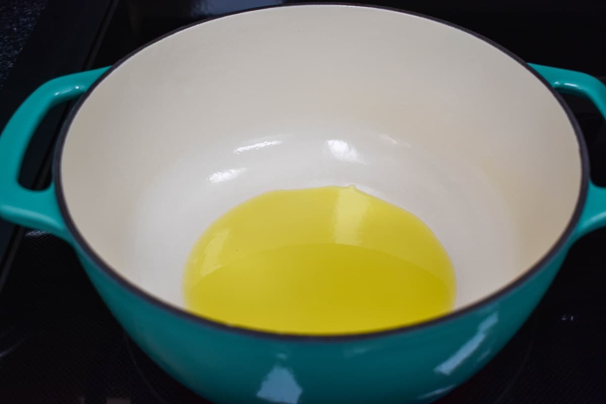Olive oil in a light blue and white pot.