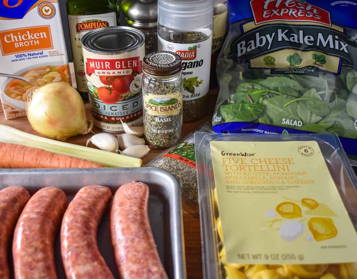 The ingredients for the soup arranged on a wood cutting board.