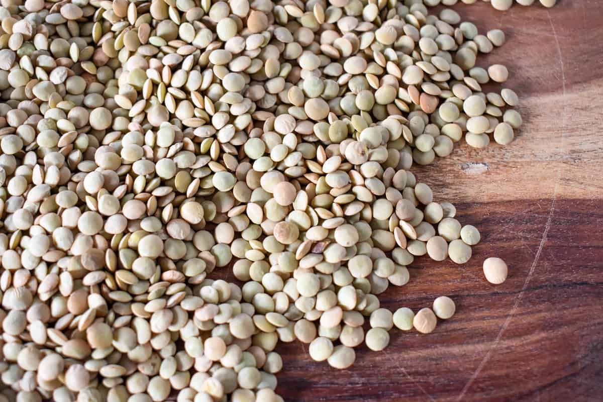 Lentils on a wood cutting board.