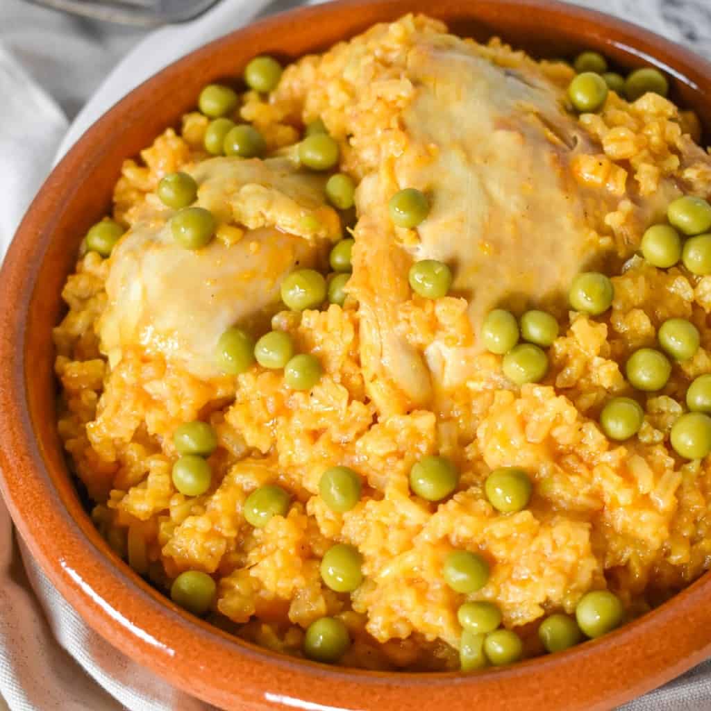 An image of the arroz con pollo served in a terracotta bowl.