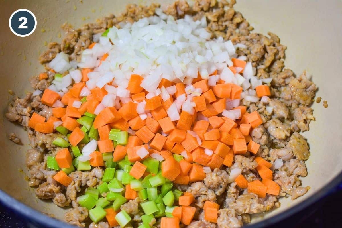 Diced onion, carrot, and celery added to the browned Italian sausage.