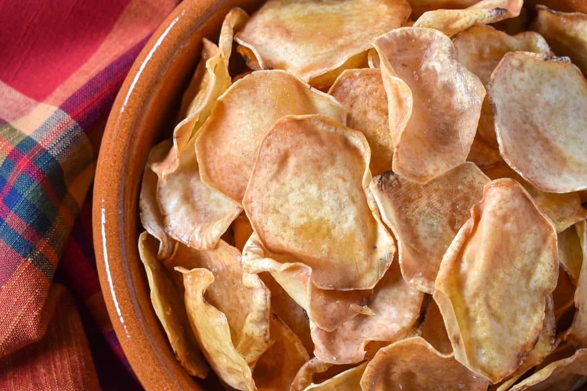 A close up image of the malanga chips served in a terracotta bowl.