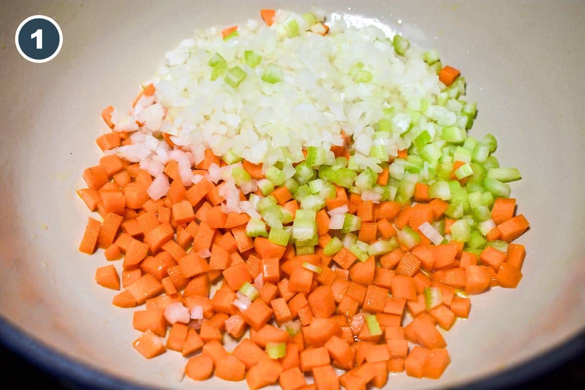 Diced onion, carrot, and celery cooking in a skillet for turkey meatloaf.