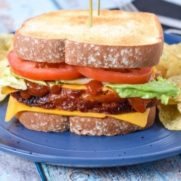 The meatloaf sandwich served on a blue plate with potato chips.