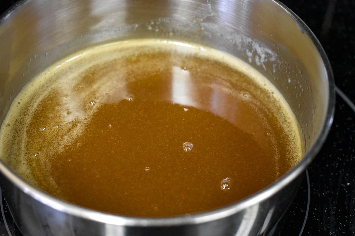 A close-up of the caramel sauce in a saucepan.