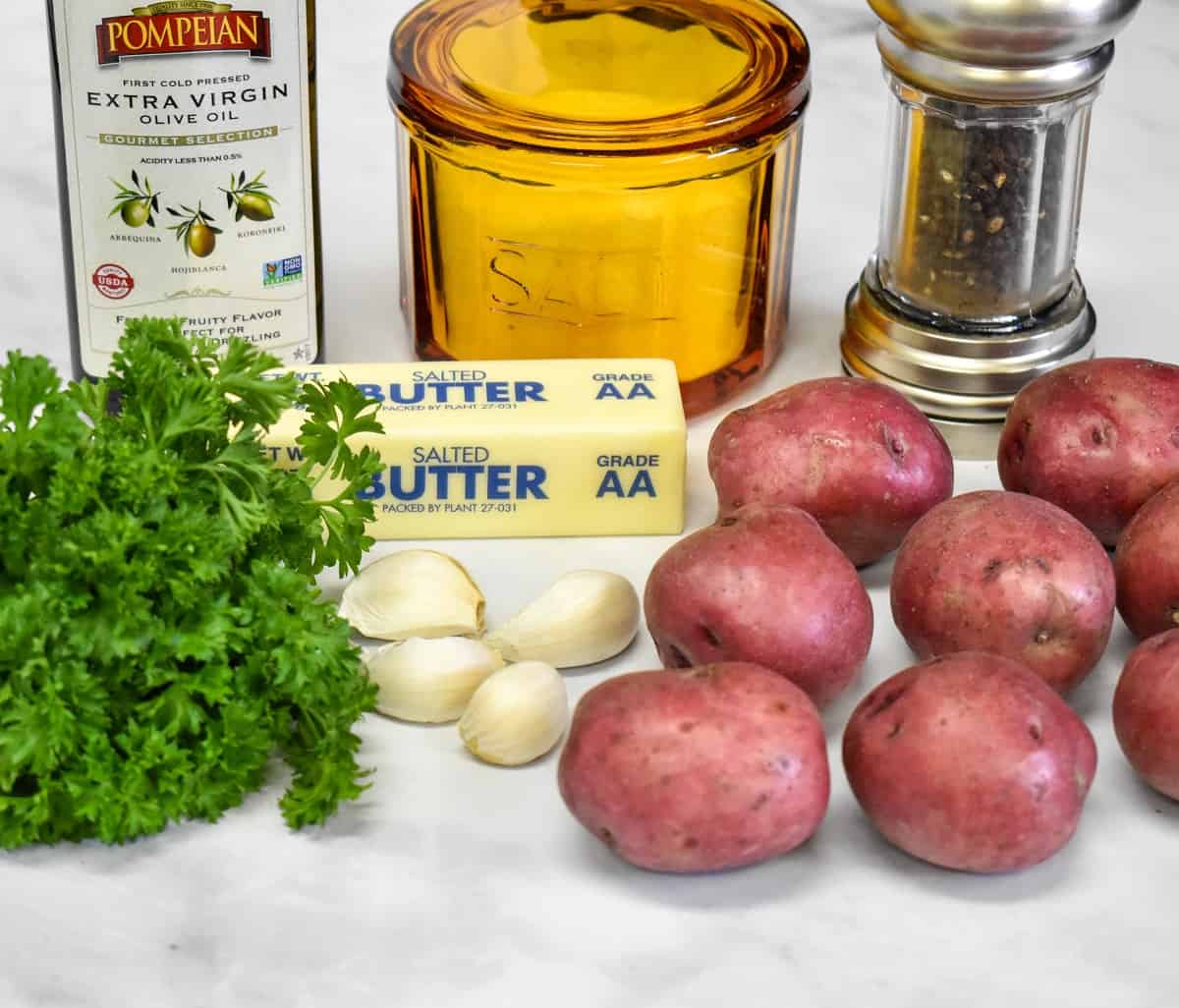 The ingredients for the parsley potatoes arranged on a white table.