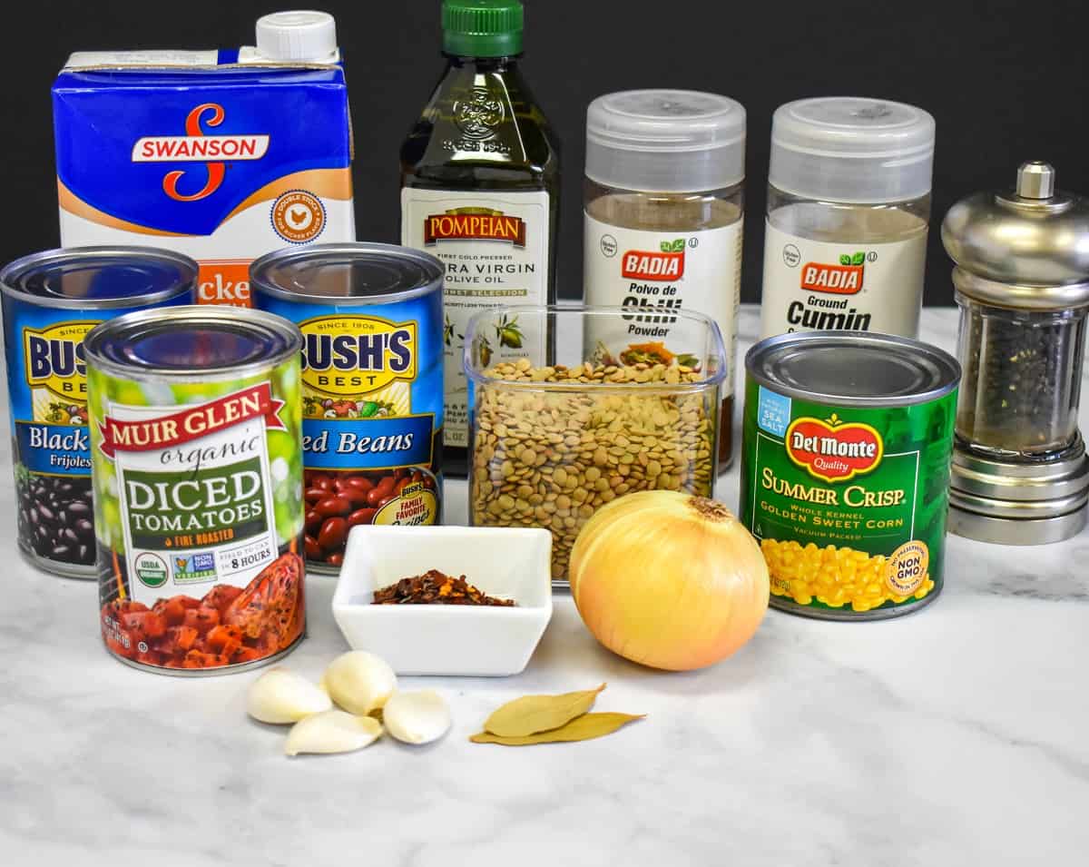 The ingredients for the chili arranged on a white table.