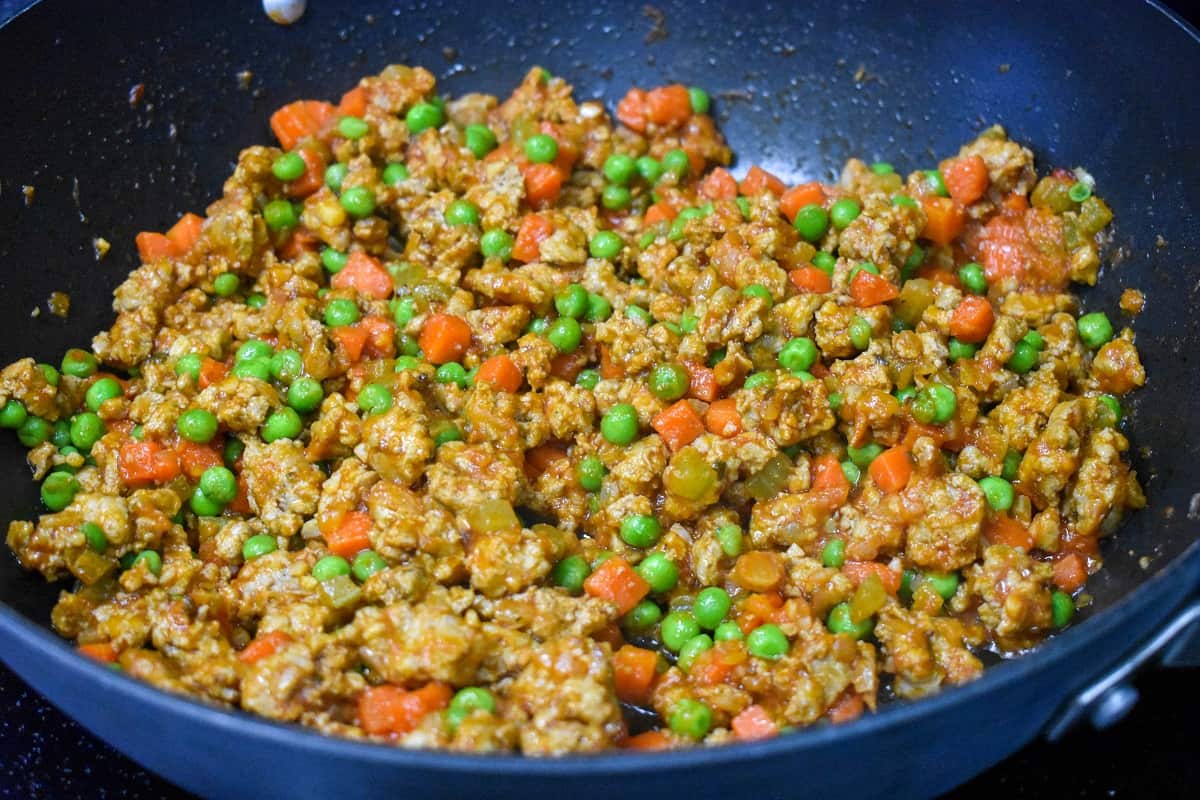 The finished ground turkey filled in a large, black skillet.