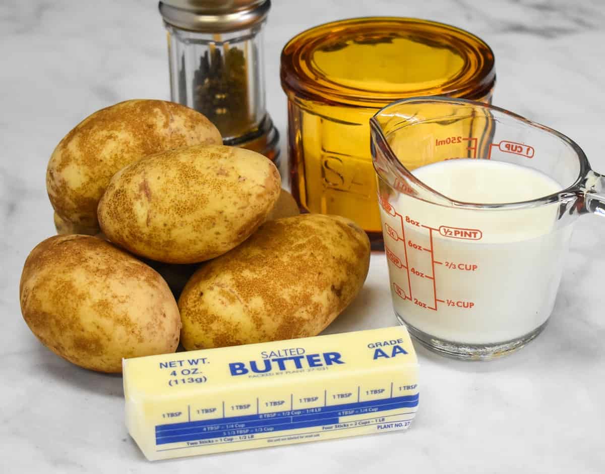 The ingredients for the mashed potato topping arranged on a white table.