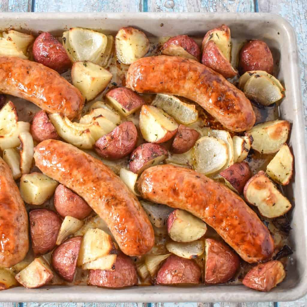 The finished baked Italian sausage and potatoes on the sheet pan.