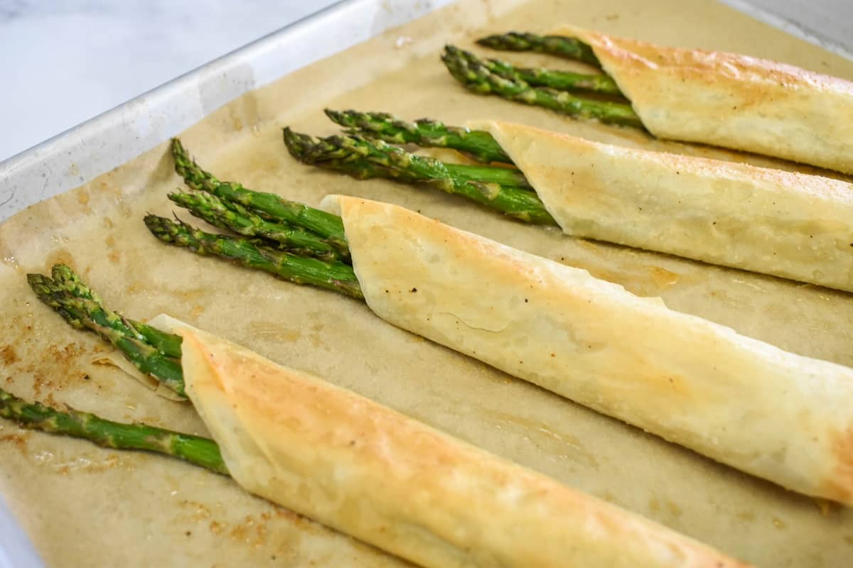 The baked bundles still a baking sheet lined with parchment paper.