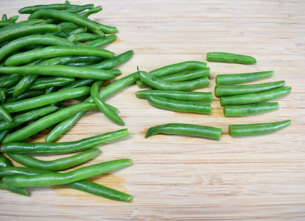 Green beans on a wood cutting board.