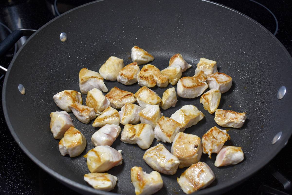 The chicken pieces after being turned once with the browned side up.