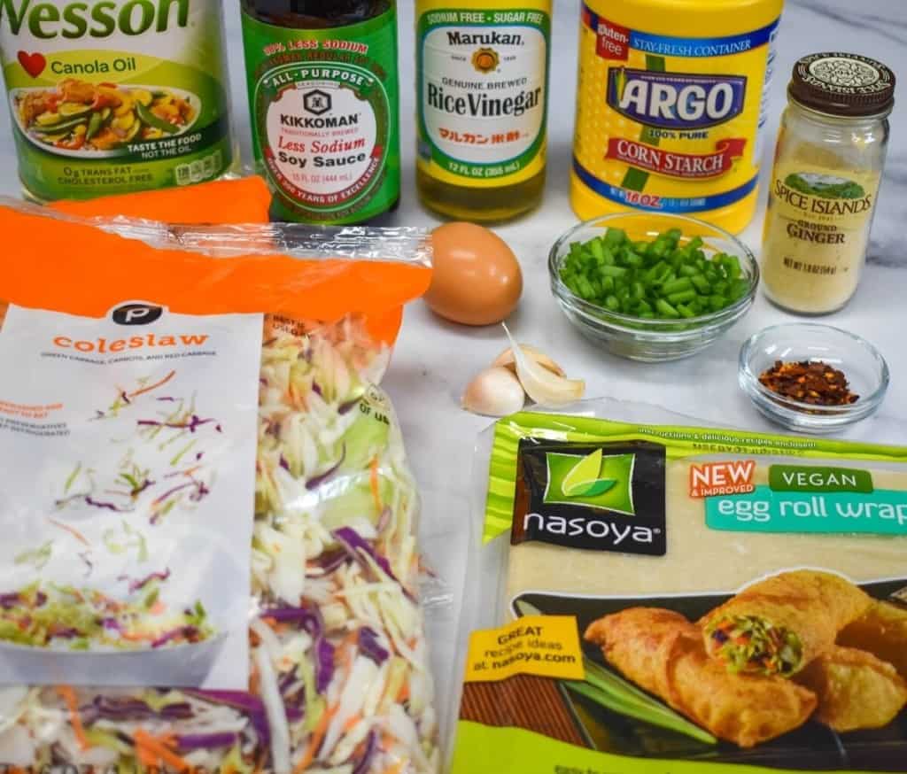 The ingredients for the vegetable egg rolls arranged on a table.