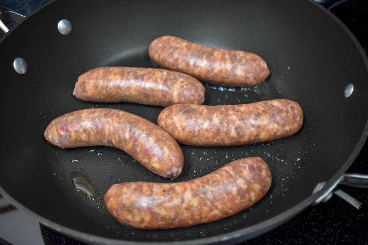 Five raw Italian sausage links in a little oil in a large nonstick skillet.