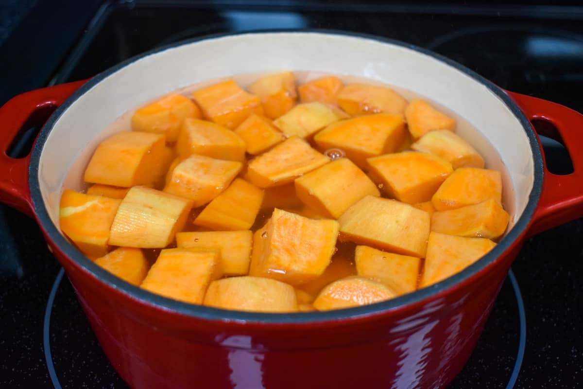 Cut sweet potatoes in a pot with water.