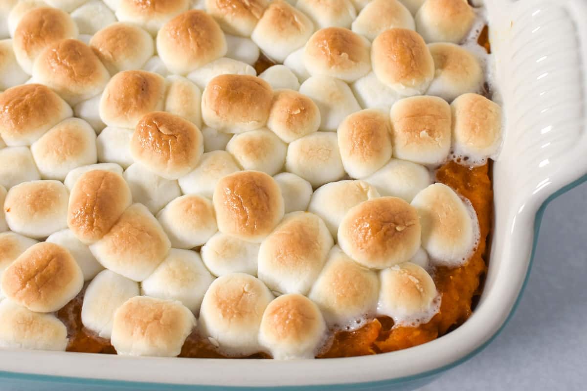 A close up image of the baked casserole with golden browned marshmallows on top.