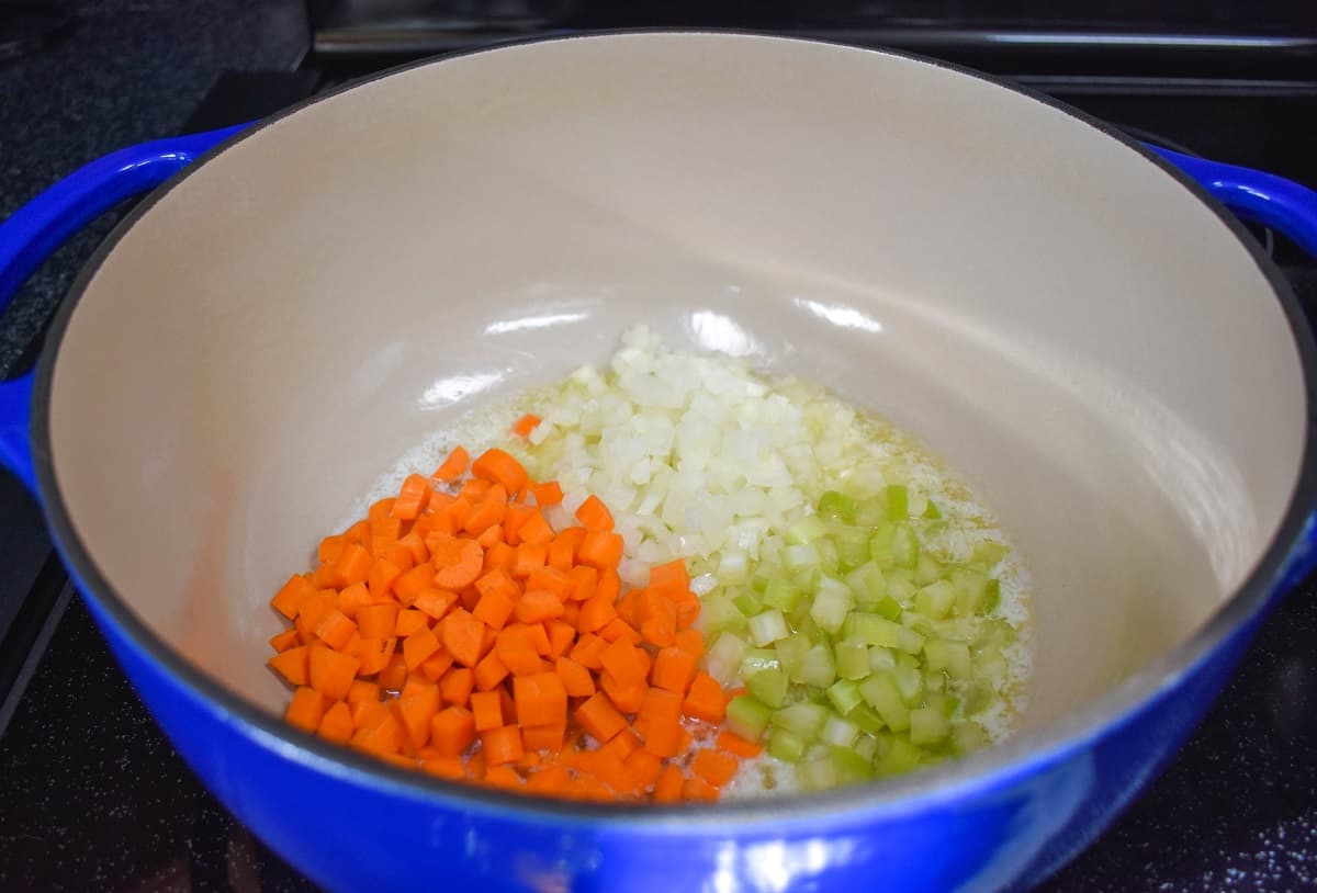 Diced onions, carrots, and celery in a large pot.