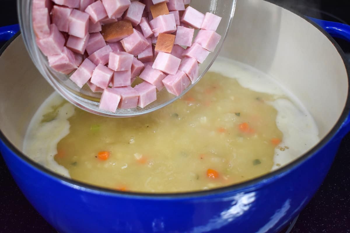 Cubed ham about to be added to the soup in the pot.