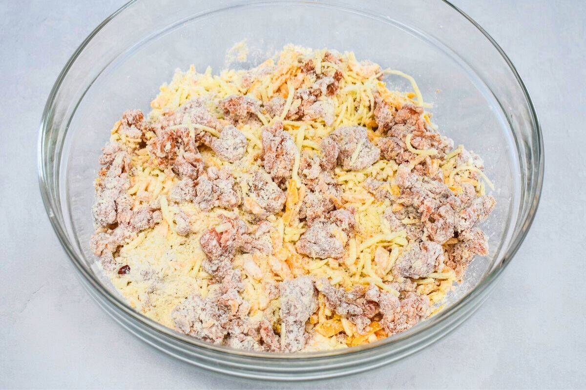 The mixed ingredients while still crumbly in a large, glass bowl.