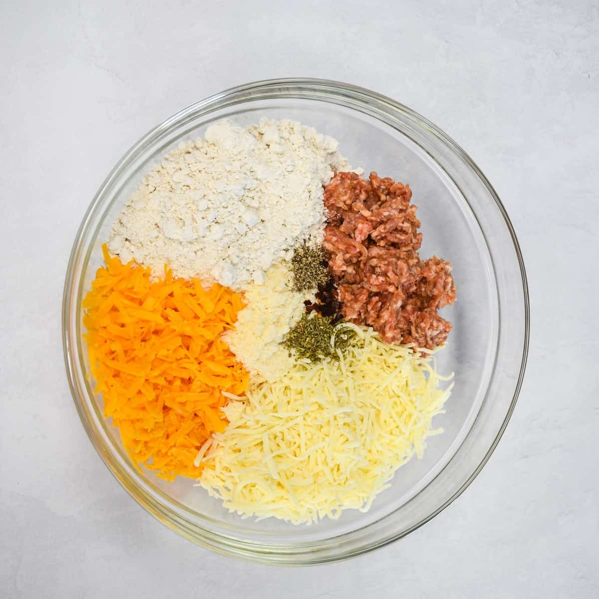 The ingredients in a large glass bowl before mixing.
