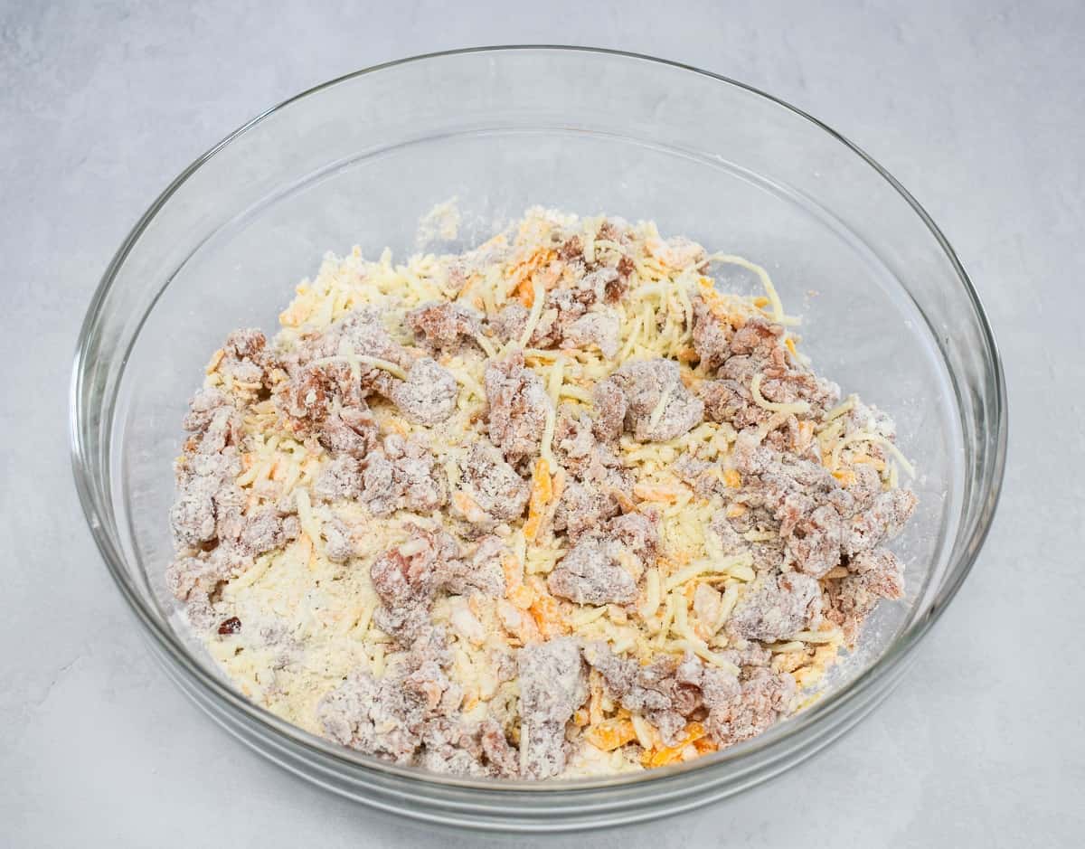 The mixed ingredients while still crumbly in a large, glass bowl.