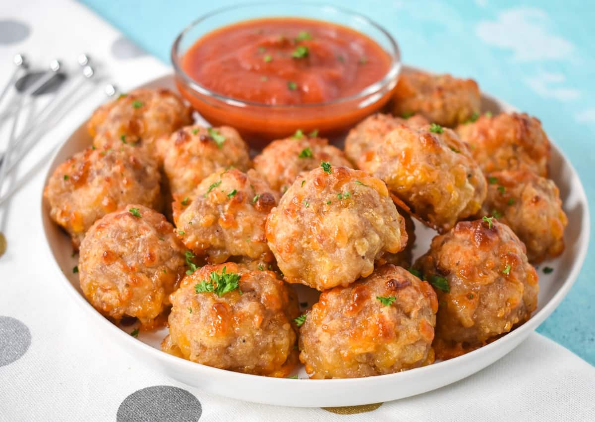 A close up of the appetizer arranged on a white plate and served with marinara sauce.