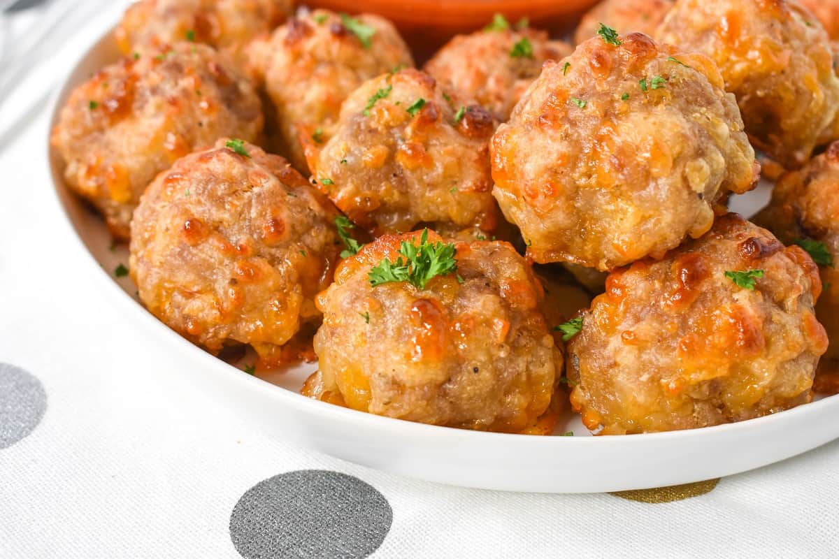 A close up image of the baked sausage balls served on a white plate.