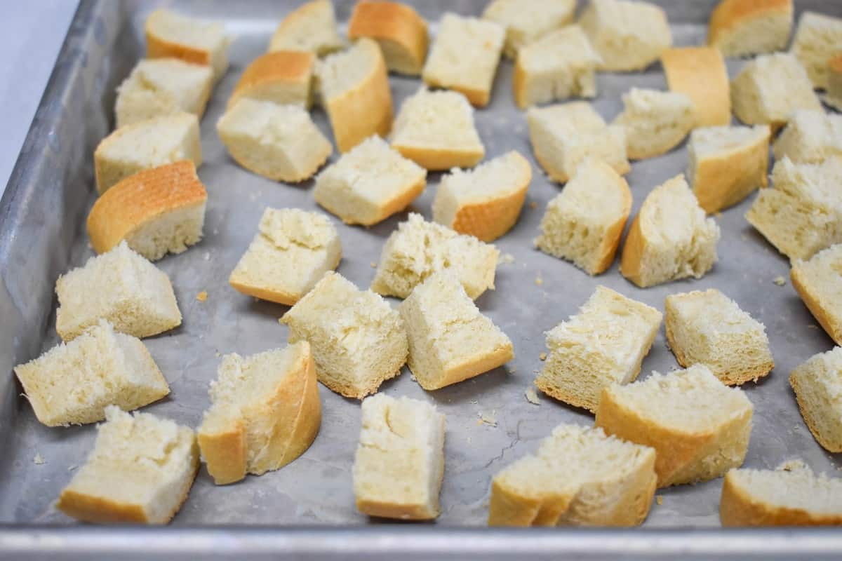 An image of toasted bread cubes on a baking sheet.