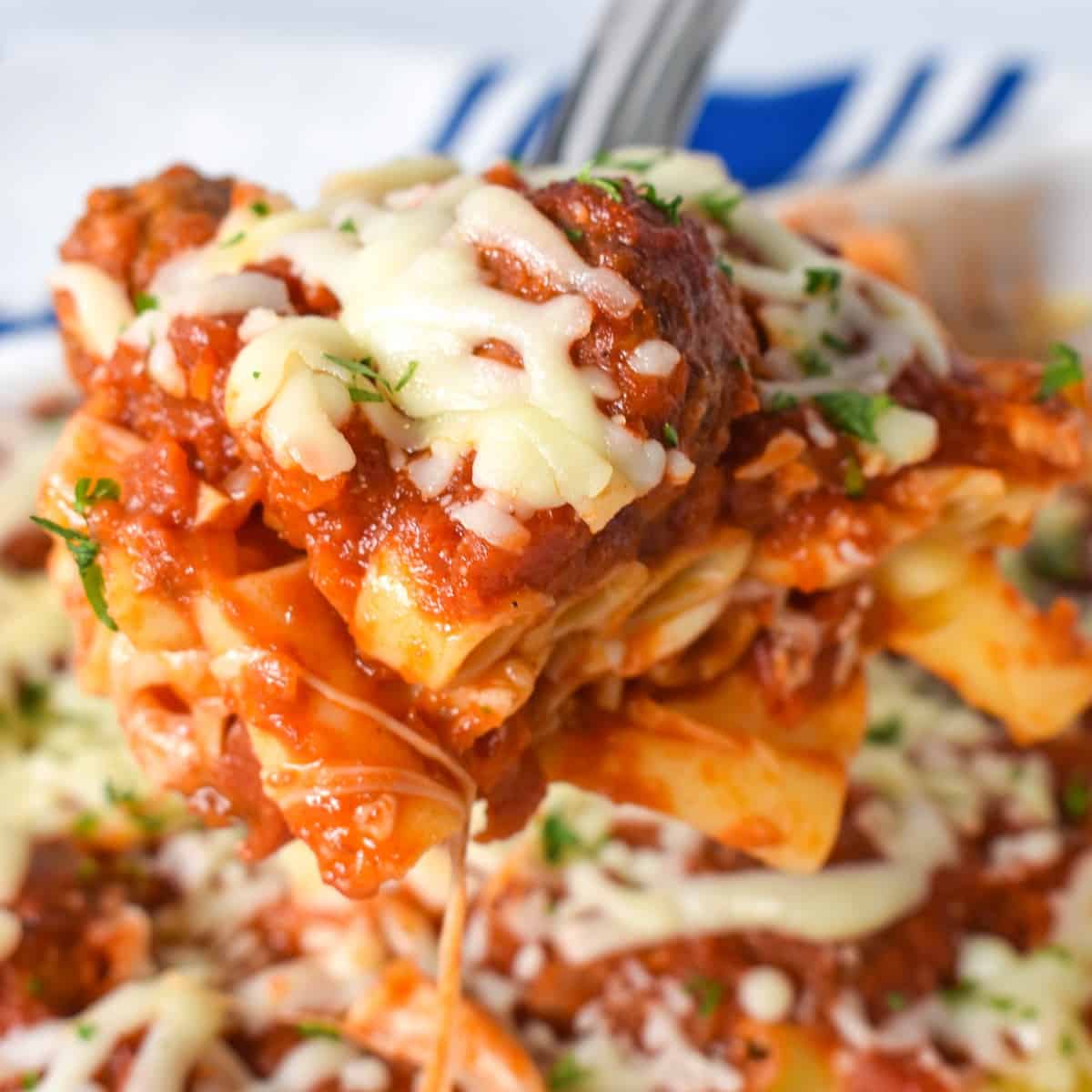 A close up image of a serving of the baked pasta with meatballs.