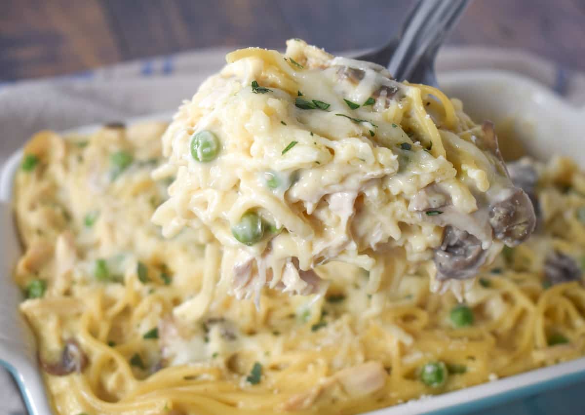 A close up of a serving of the casserole held up with a serving spoon.