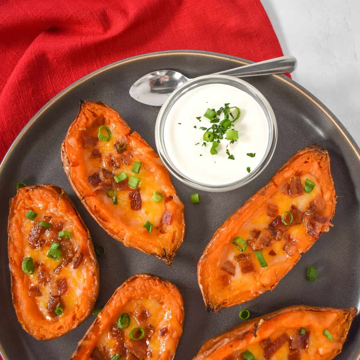 An image of the finished appetizer served on a gray platter with a side of sour cream.