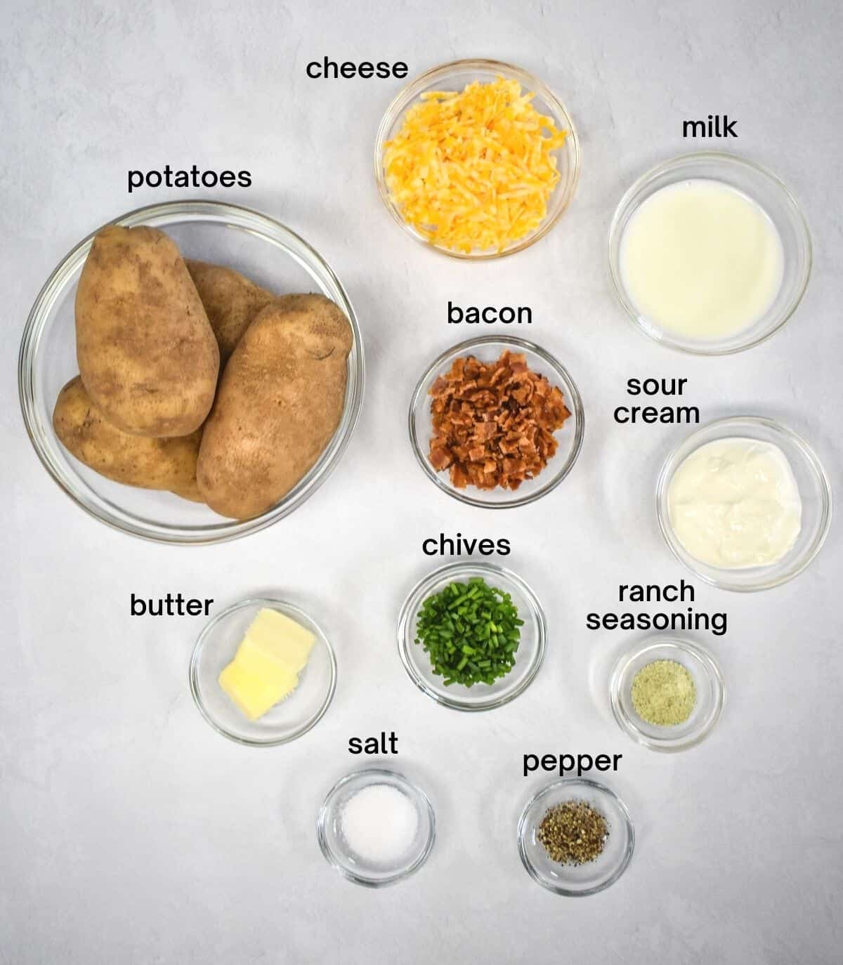 The ingredients labeled and arranged in glass bowls on a white table.
