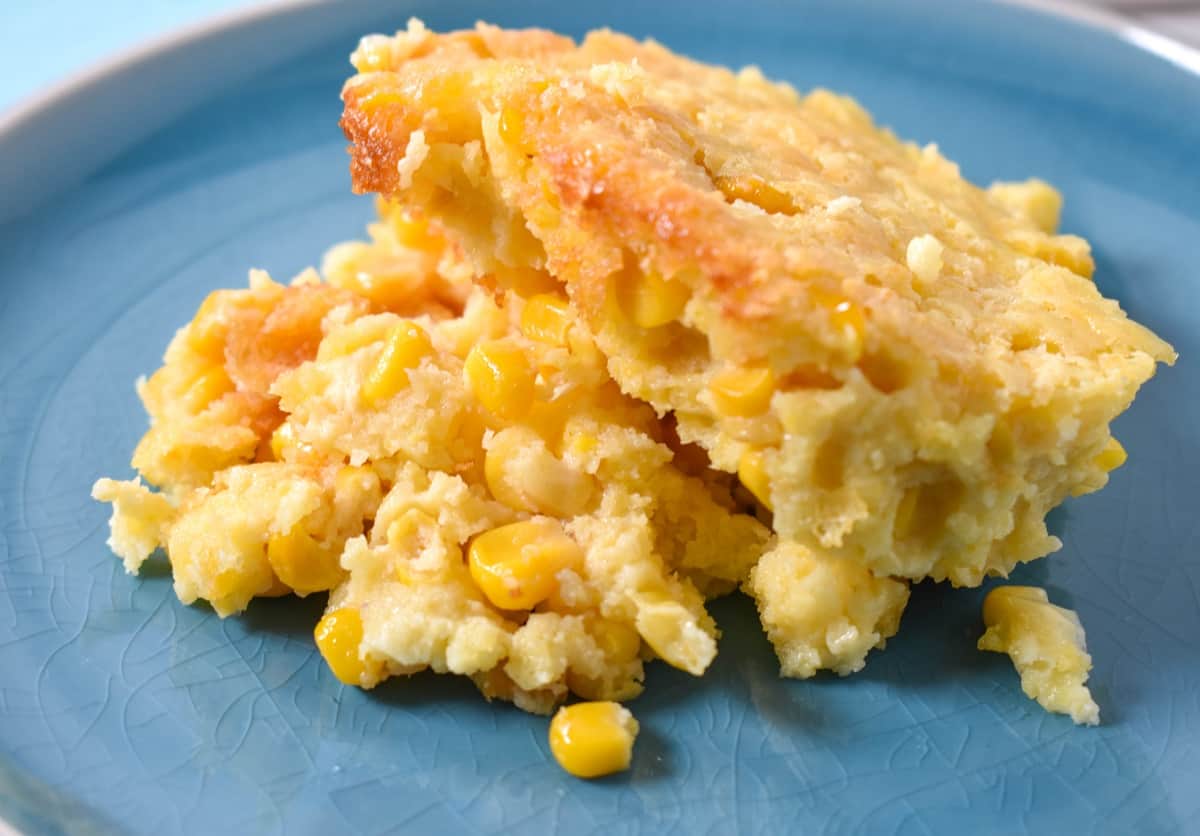A serving of the corn casserole served on a light blue plate.