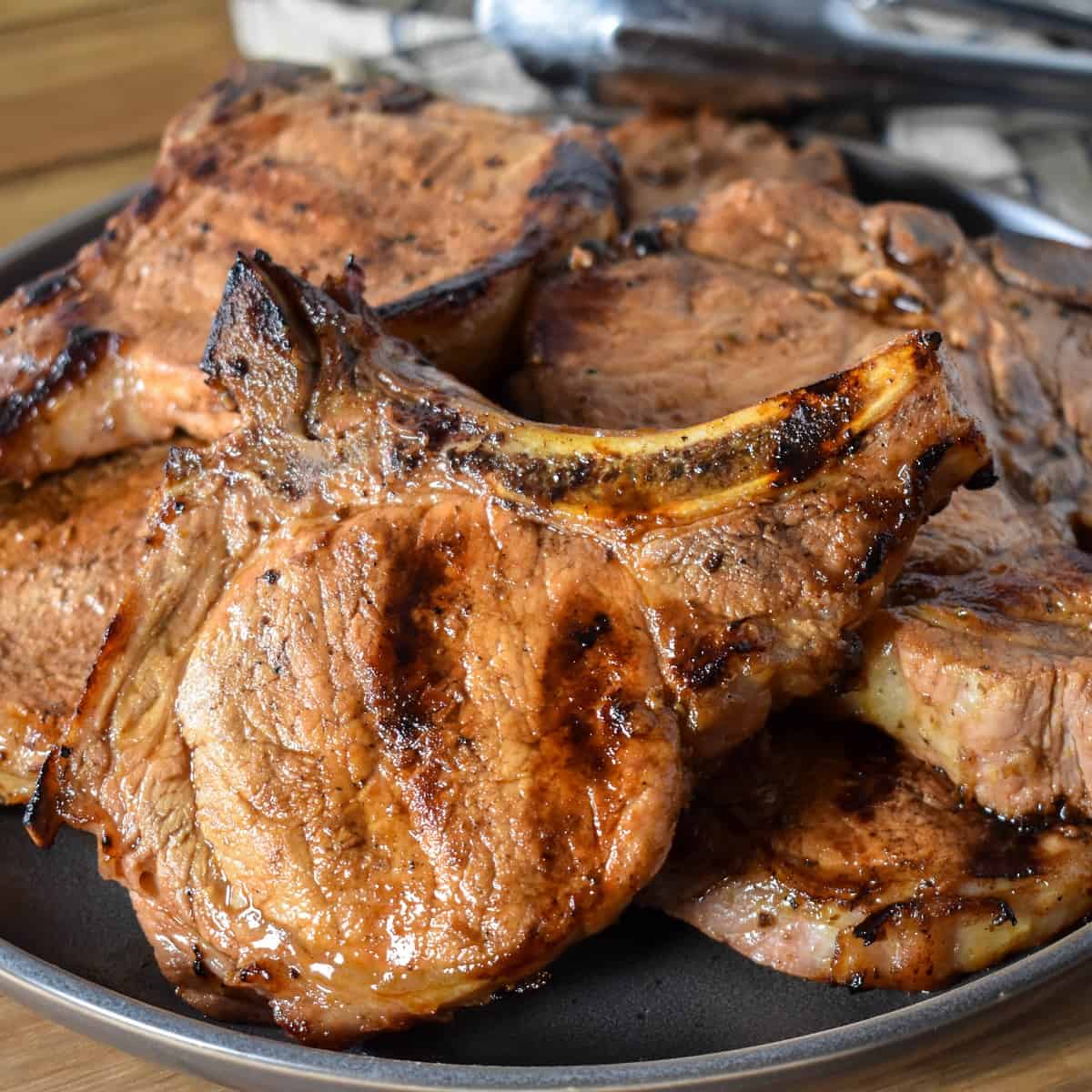An image of the grilled pork chops set on a gray platter.