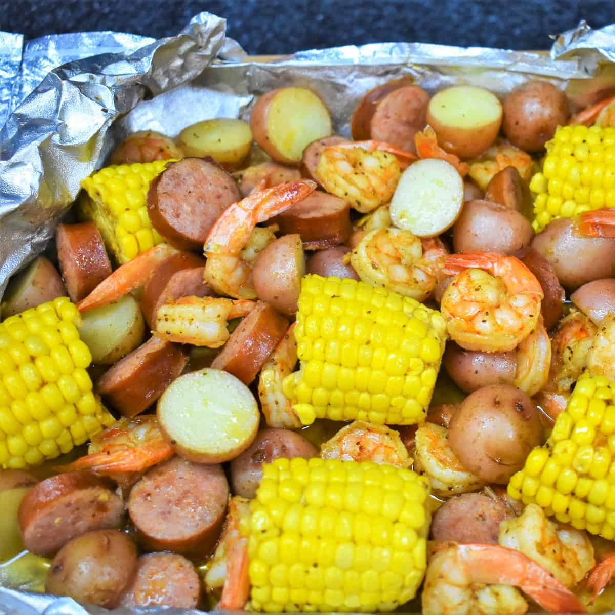 An image of the cooked shrimp dinner in the opened foil packet.