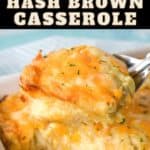 An image of a serving of the cheesy hash brown casserole held up by a large serving spoon over the baking dish.