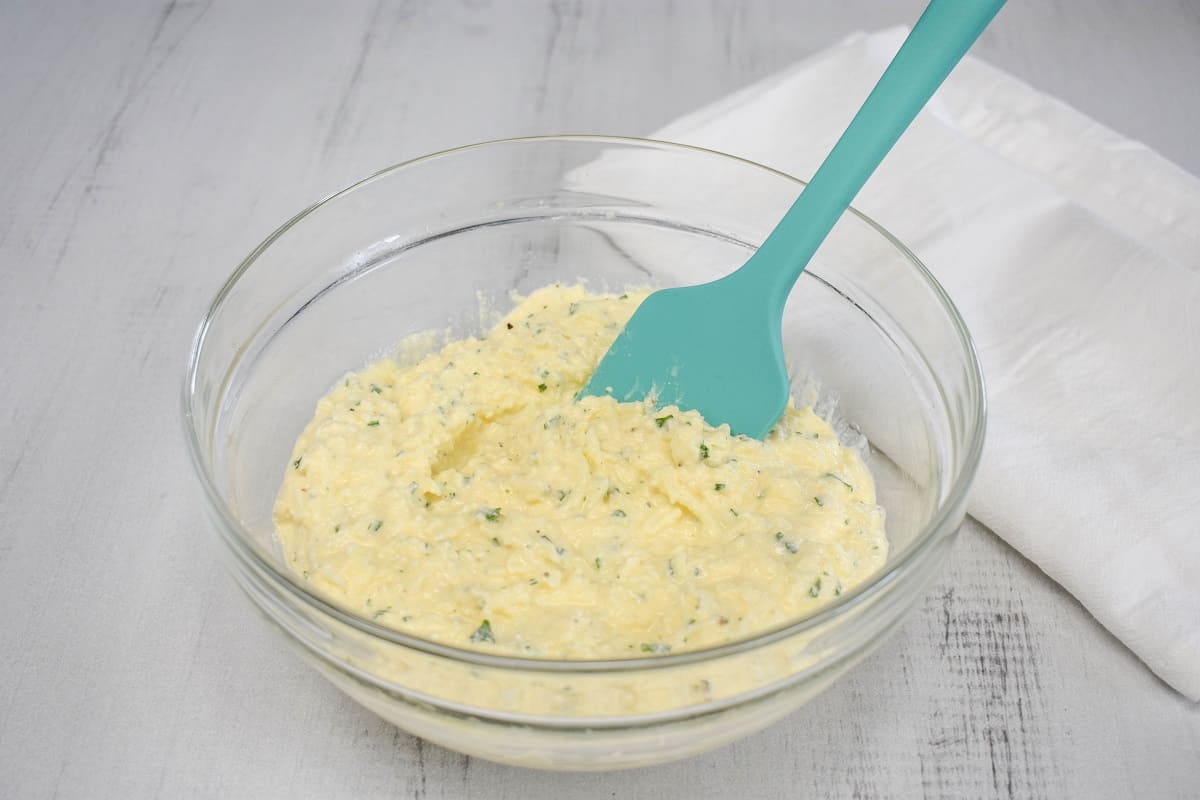 An image of the combined cheese mixture in a large, glass bowl.