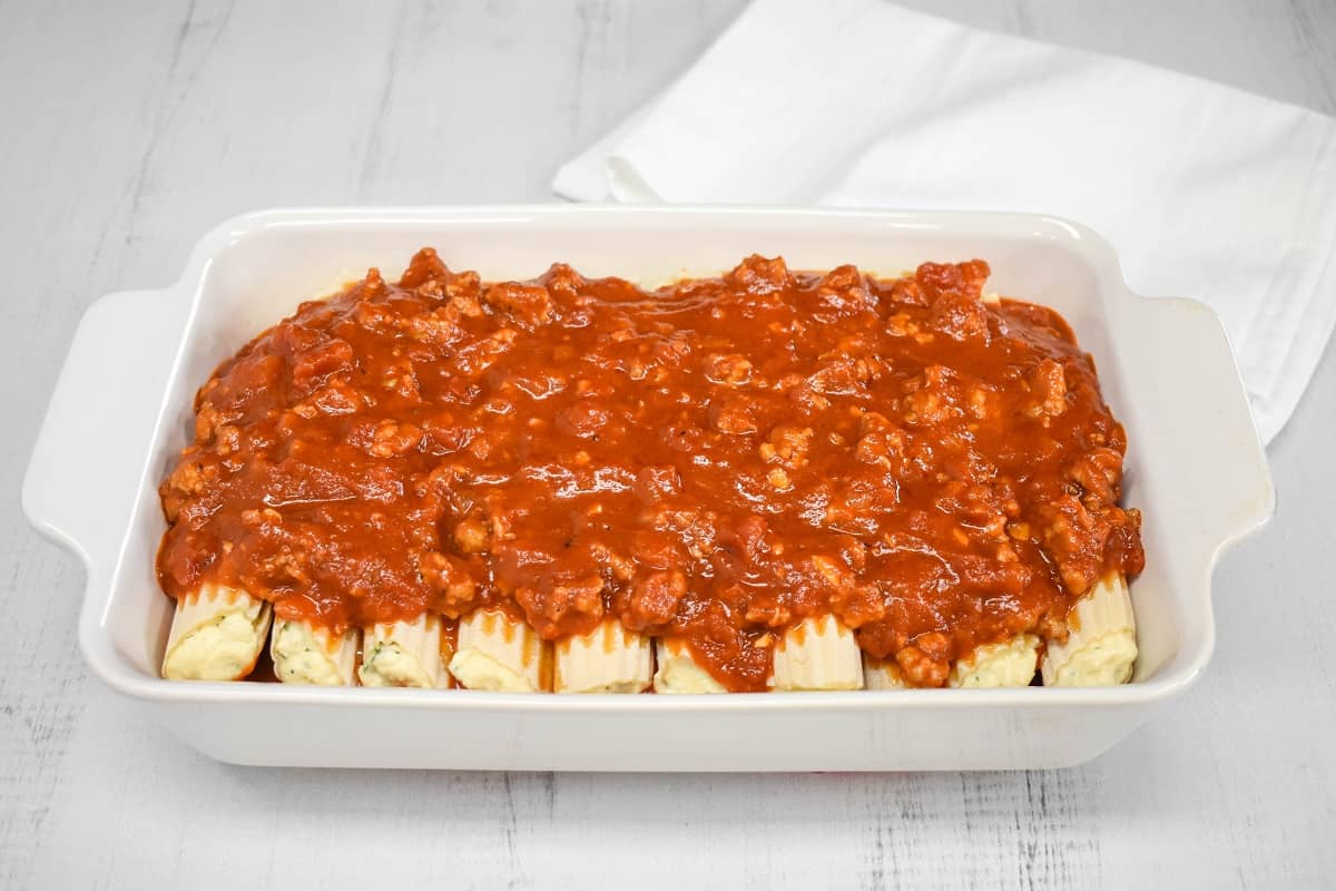 An image of sauce on the manicotti shells.