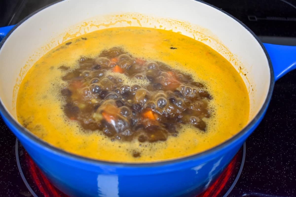 The black bean soup simmering in a large pot.