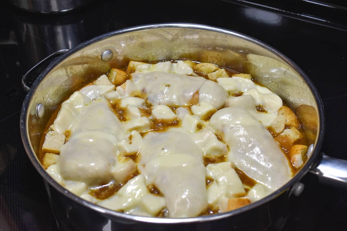 The finished onion chicken still in the skillet with the cheese melted on top.