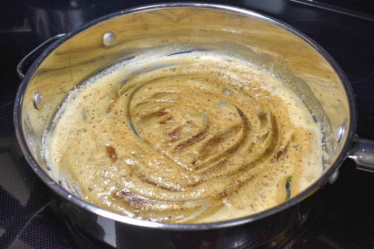 A butter and flour mixture cooking in a large skillet.