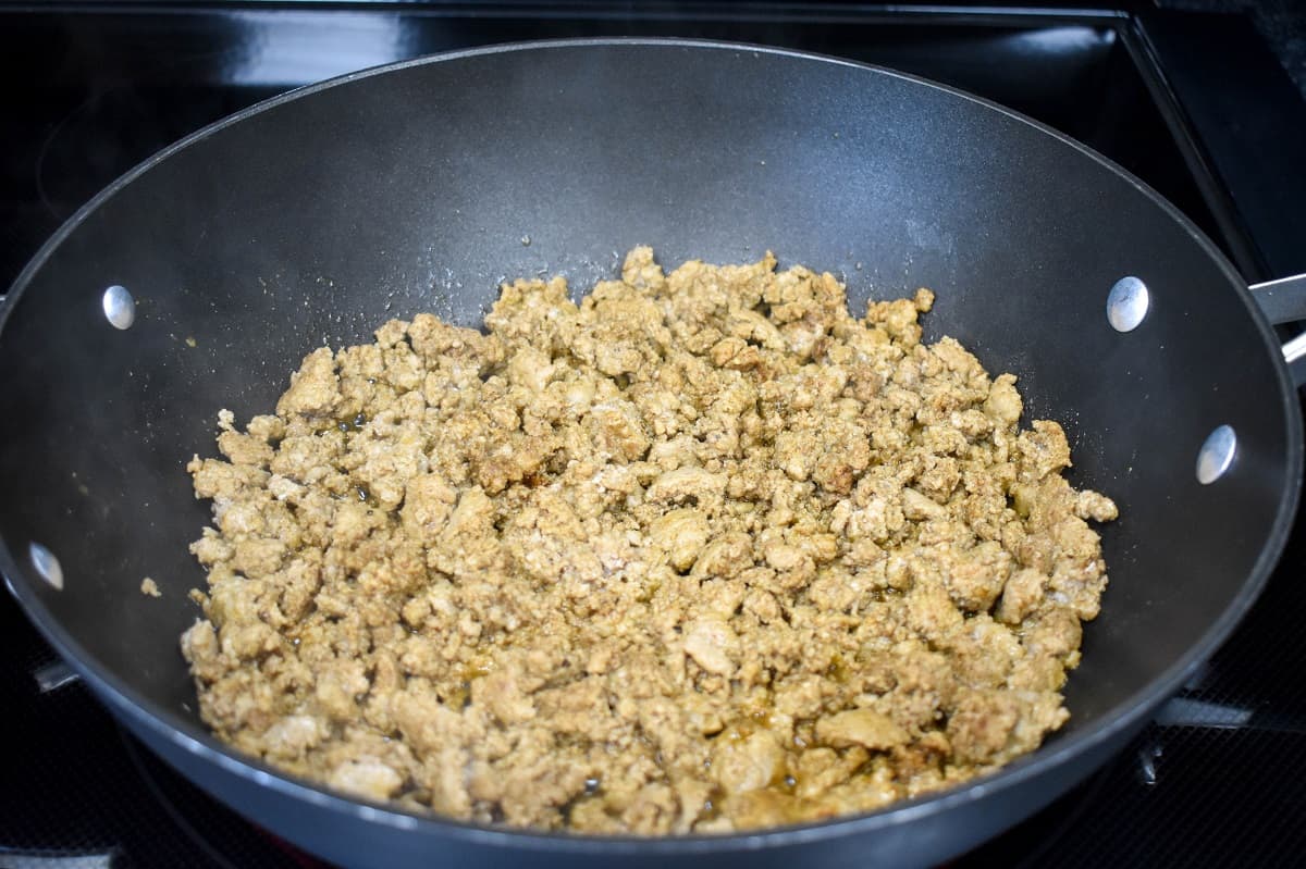 Browned ground turkey in a large, black skillet.