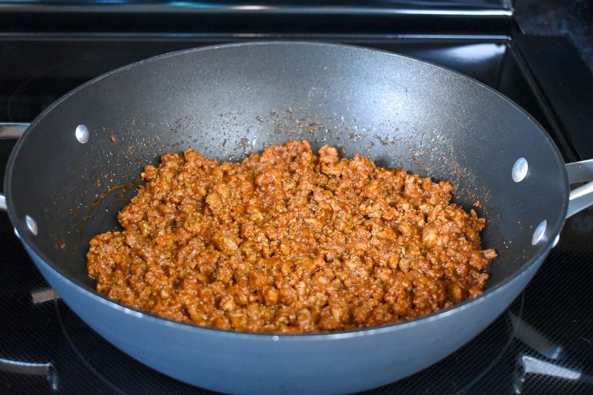 The finished ground turkey taco mixture in a large, black skillet.