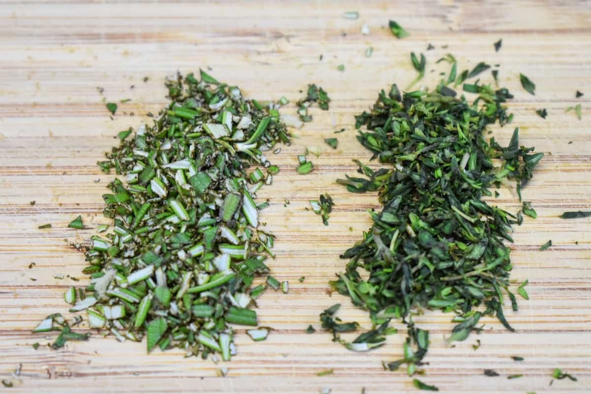 Chopped thyme and rosemary on a wood cutting board.Chopped Thyme and Rosemary Image