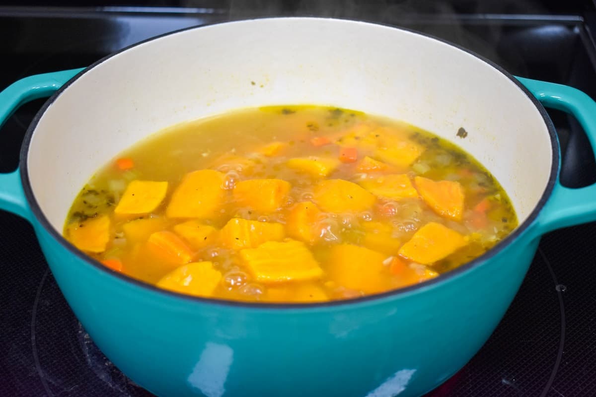 The sweet potatoes and broth in the blue and white pot.