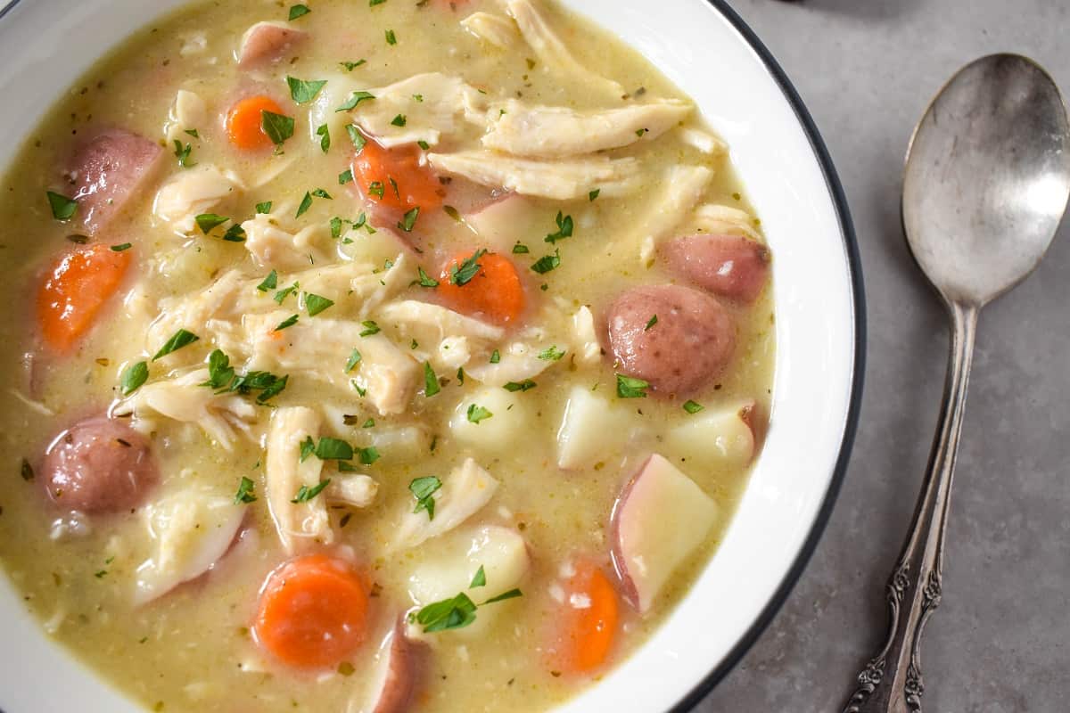 A close-up image of the finished chicken stew garnished with chopped parsley.