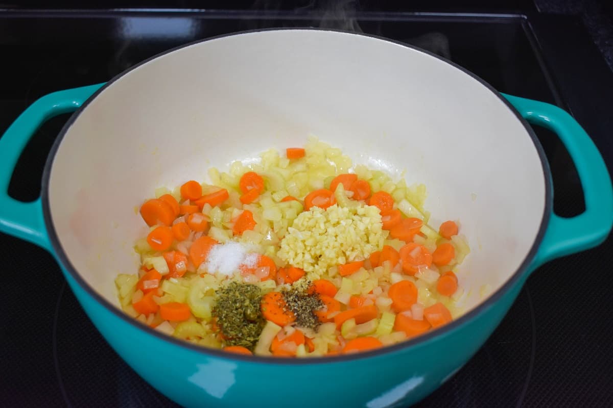 The garlic and seasoning added to the vegetables in the pot.