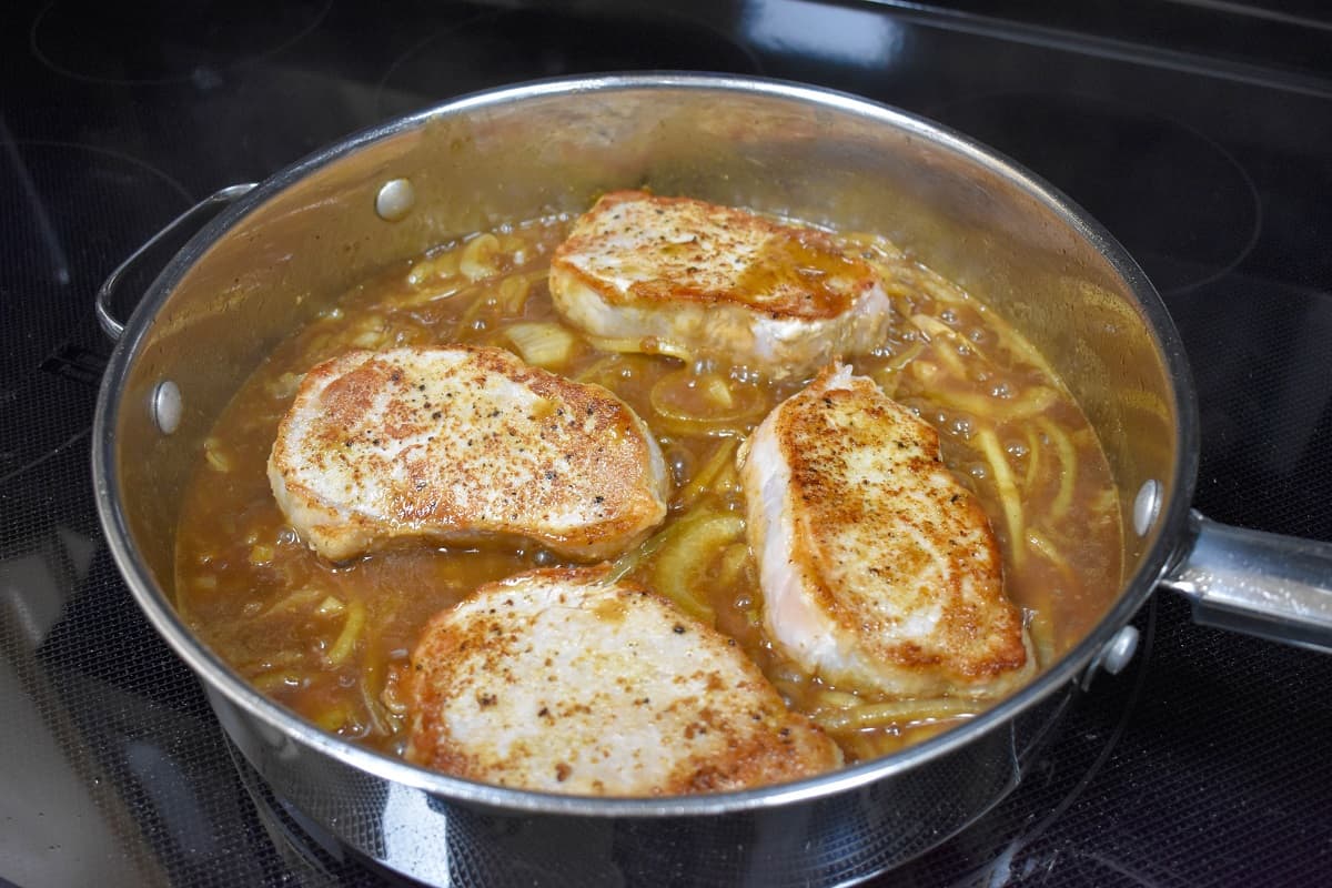Four pork chops in the onion gravy.
